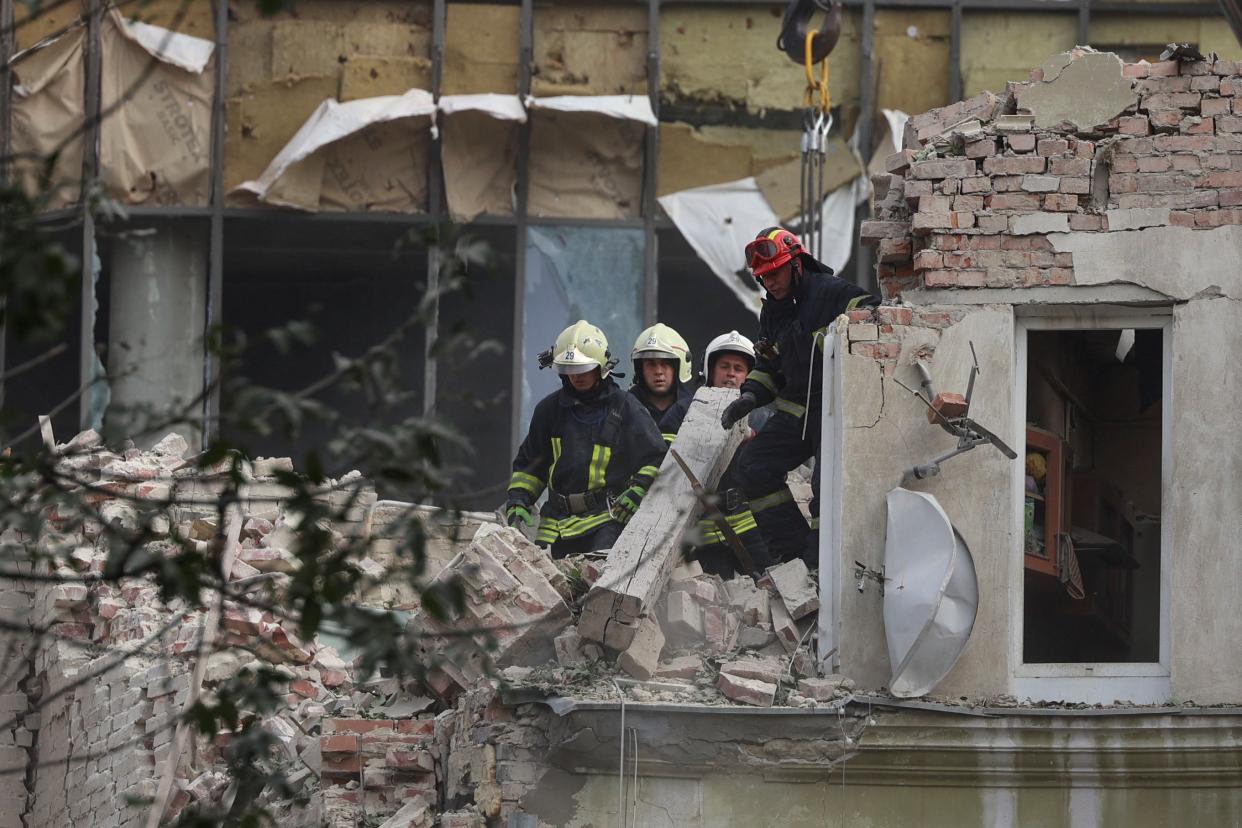 Rescuers work at a site of the residential building hit by a Russian missile strike in Lviv (REUTERS)