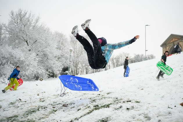 A man takes to the air after hitting a ramp while sledging in Alexandra Park on Monday