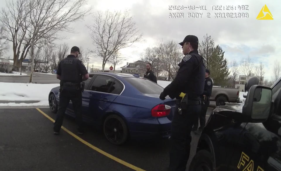 In this image taken from from police body-worn camera video provided by the Farmington City, Utah, Police Department, police officers surround a vehicle during a traffic stop, Wednesday, March 1, 2023, in Farmington, Utah. The footage released by the suburban police department in Utah on Wednesday, Mach 8, 2023, shows five officers opening rounds of fire into all sides of a car after they can be heard alerting each other that the driver, 25-year-old Chase Allan, has a gun. The Allan family has since raised questions about police actions. (Farmington City Police Department via, AP)