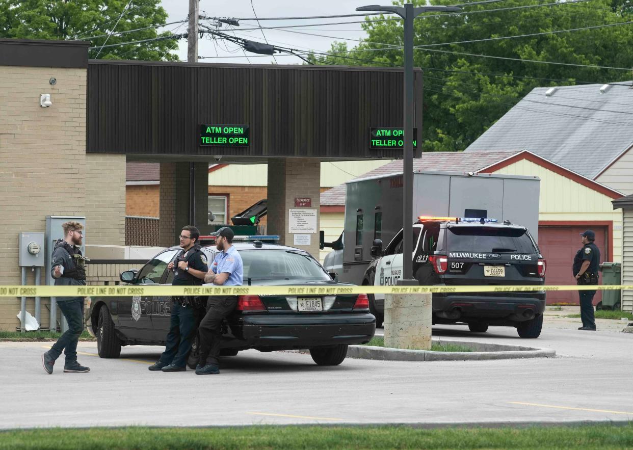 Milwaukee police gather at North Shore Bank, 7927 W. Capitol Drive, on July 13 where suspects robbed an armored truck and killed a security guard.