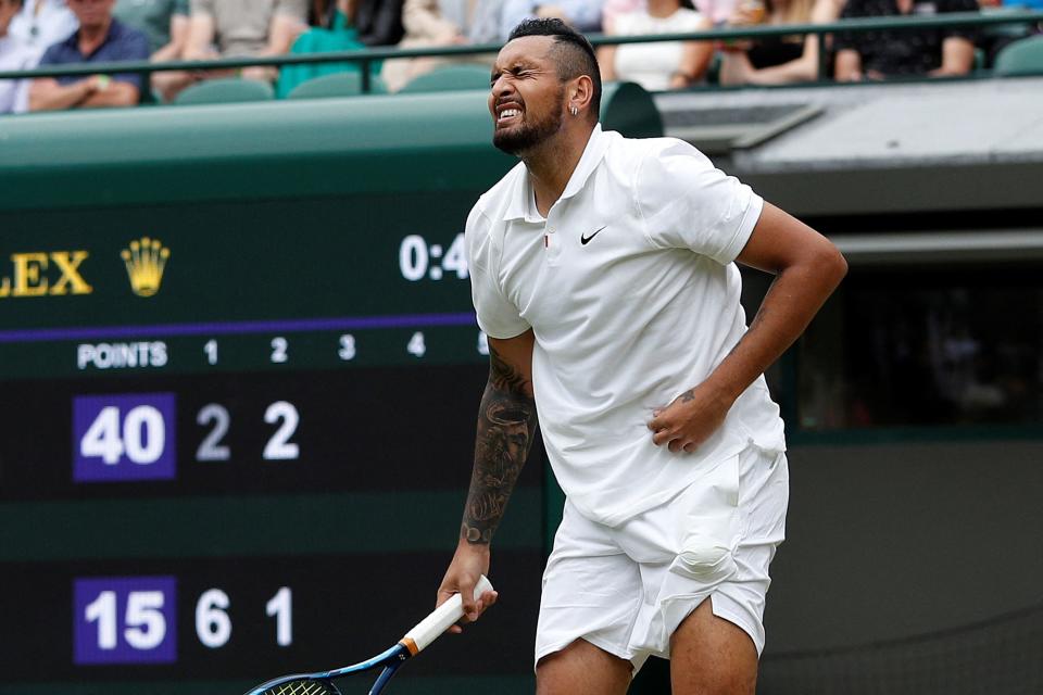 Nick Kyrgios (pictured) reacts in pain after serving againsT Felix Auger-Aliassime.