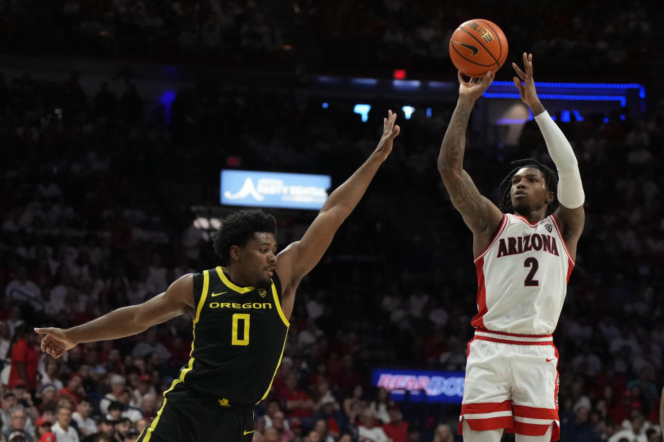 Arizona guard Caleb Love (2) shoots over Oregon guard Kario Oquendo during the second half of an NCAA college basketball game, Saturday, March 2, 2024, in Tucson, Ariz. (AP Photo/Rick Scuteri)