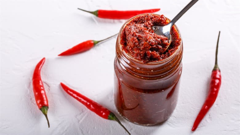 Sauce jar and chilies