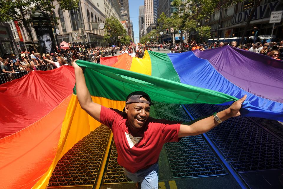 Mark Wilson carries a rainbow flag during San Francisco's 42nd annual gay pride parade on Sunday, June 24, 2012. Organizers say more than 200 floats, vehicles and groups of marchers took part in the parade.