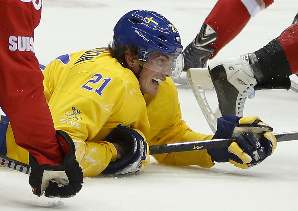 Sweden forward Loui Eriksson hits the ice in the third period of a men's ice hockey game against Switzerlanad at the 2014 Winter Olympics, Friday, Feb. 14, 2014, in Sochi, Russia. (AP Photo/Mark Humphrey)