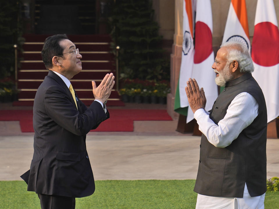 Indian Prime Minister Narendra Modi greets his Japanese counterpart Fumio Kishida before their meeting in New Delhi, Saturday, March 19, 2022. Kishida is meeting with Modi to strengthen their partnership in the Indo-Pacific and beyond in view of China’s growing footprint in the region, an Indian official said Thursday. (AP Photo/Manish Swarup)