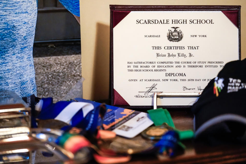 Brian Lilly Jr.'s high school diploma is displayed in Brenda and Brian Lilly's home, Thursday, Oct. 13, 2022, in Easton, Conn. Brian Lilly Jr., 19, who committed suicide on Jan. 4, 2021, was a rower at University of California San Diego. The Lillys have filed a wrongful death lawsuit against the university and the rowing coach, Geoff Bond, who is no longer with the school. (AP Photo/Julia Nikhinson)