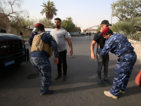 Iraqi security forces inspect people during a protest near the main provincial government building in Basra, Iraq, July 20, 2018. REUTERS/Essam al-Sudani