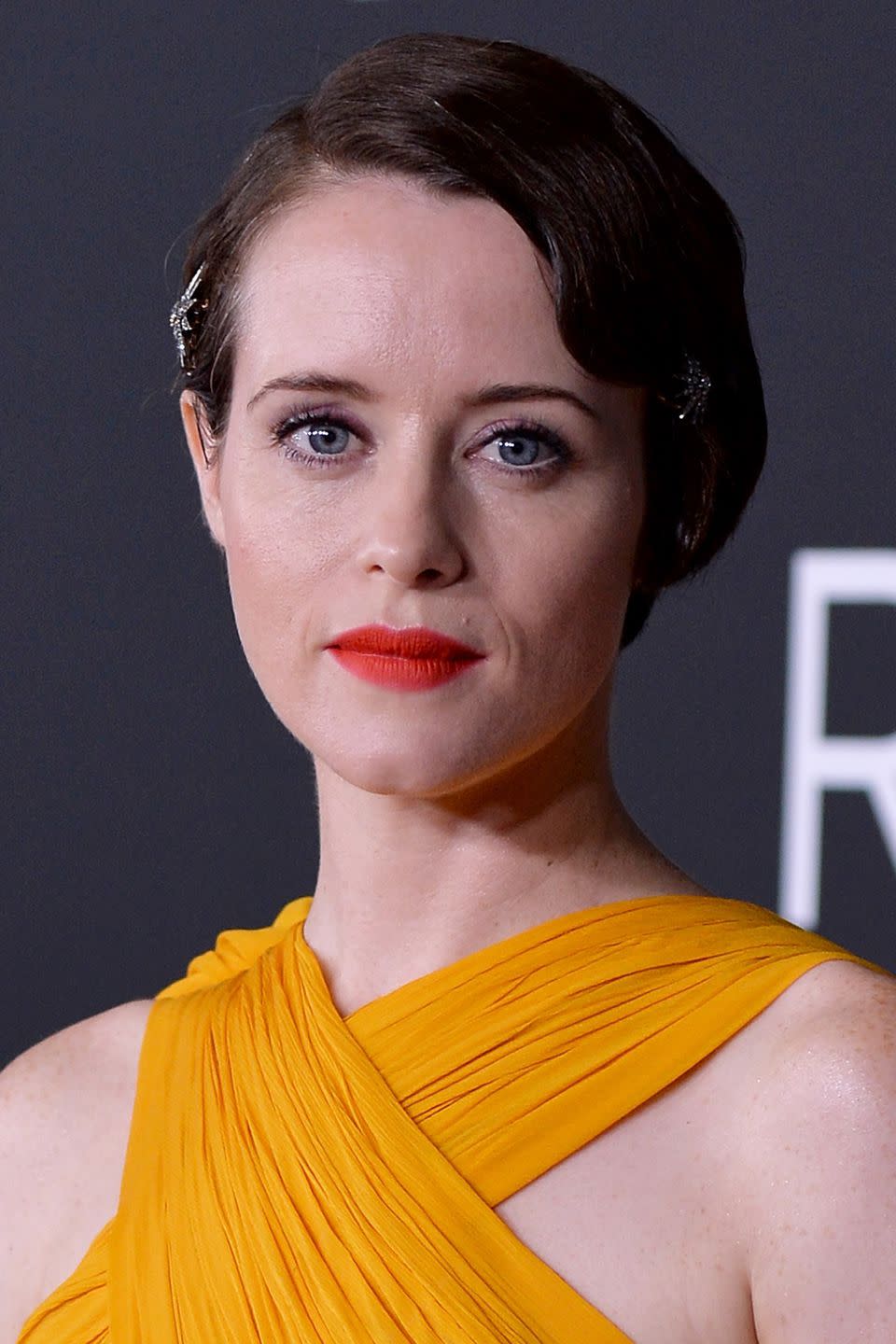 <p>Claire Foy was the picture of elegance at the Washington premiere of <em>First Man</em>, with her modern-take on Flapper hair and soft red lipstick contrasting her yellow dress. The actress' lipstick was probably the work of a new powder lip lacquer formula, such as Chanel's <a rel="nofollow noopener" href="https://www.feelunique.com/p/CHANEL-ROUGE-ALLURE-LIQUID-Powder-9ml?option=47756&gclid=Cj0KCQjwl9zdBRDgARIsAL5Nyn1ASMJdkqGLhusZfcF1vyYq3RzsPXeSu7ii9p2r_8Bjbtbo__XiEMAaAgRjEALw_wcB&gclsrc=aw.ds" target="_blank" data-ylk="slk:Rouge Allure Liquid Powder;elm:context_link;itc:0;sec:content-canvas" class="link ">Rouge Allure Liquid Powder</a>, which provides a blurred matte effect on the lips. As for recreating her hairstyle, use L'Oreal Professionnel's <a rel="nofollow noopener" href="https://www.mankind.co.uk/l-oreal-professionnel-tecni-art-pli-shaper-190ml/10897276.html?affil=thgppc&utm_source=criteo&utm_medium=cpc&utm_campaign=DynamicRemarketingCriteo&switchcurrency=GBP&shippingcountry=GB" target="_blank" data-ylk="slk:Techni Art Pli;elm:context_link;itc:0;sec:content-canvas" class="link ">Techni Art Pli</a> after curling your tresses to slick-back your waves and secure them into a tight up-do.<br></p>