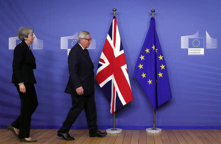 European Commission President Jean-Claude Juncker walks with British Prime Minister Theresa May at the European Commission headquarters in Brussels, Belgium February 20, 2019. REUTERS/Yves Herman