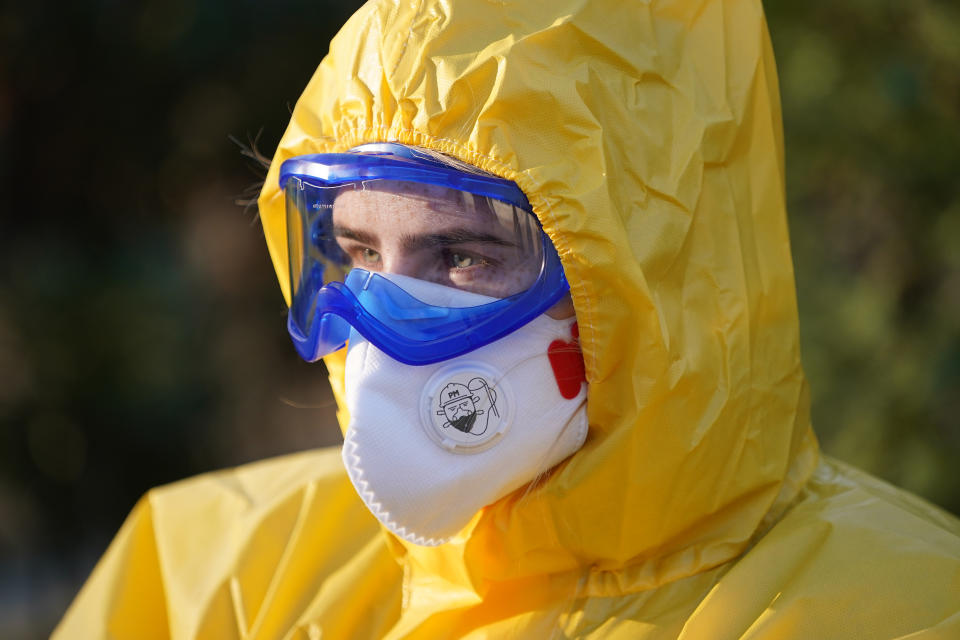 BERLIN, GERMANY - MARCH 27: A medical volunteer dressed in a protective suit, mask, gloves and goggles stands outside a tent set up near a medical practice to test people for Covid-19 infection on March 27, 2020 in Berlin, Germany. Doctor Ulrike Lipke said she set up the tent as a way to offer testing yet avoid possible coronavirus infection inside the premises of her practice. Germany is seeking to radically ramp up its coronavirus testing capacity to up to 200,000 tests per day by the end of April as a means to allow people to return to work and hence get the crisis-stricken German economy back into gear. (Photo by Sean Gallup/Getty Images)