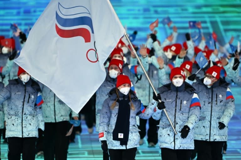 Russia's flag bearers Olga Fatkulina and Vadim Shipachev lead the delegation during the opening ceremony of the Beijing 2022 Winter Olympic Games, at the National Stadium, known as the Bird's Nest, in Beijing, on February 4, 2022. (Manan VATSYAYANA)