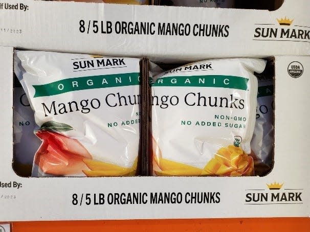 bags of frozen mango in white boxes at Costco