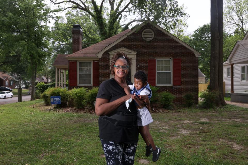 Dorothy Moore and her grandson Christopher Armstead Jr., 3, who was born with hydrocephalus, stand outside their Orange Mound home on Monday, May 2, 2022. Moore  is in the process of having lead reduction work done in her home by the city of Memphis. 