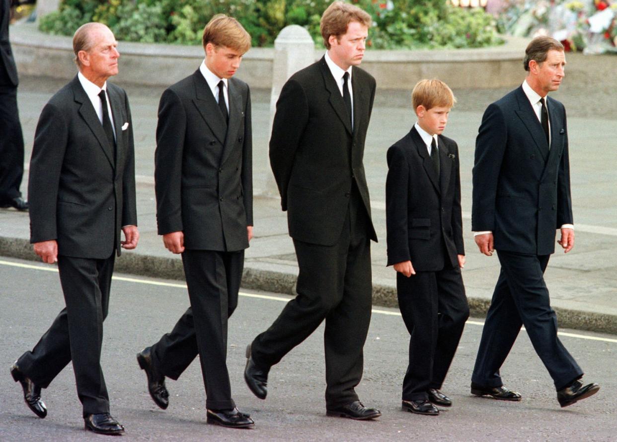 FILE - In this Sept. 6, 1997 file photo, from left, Britain's Prince Philip, Prince William, Earl Spencer, Prince Harry and Prince Charles walk outside Westminster Abbey during the funeral procession for Diana, Princess of Wales. Buckingham Palace officials say Prince Philip, the husband of Queen Elizabeth II, has died, it was announced on Friday, April 9, 2021. He was 99. Philip spent a month in hospital earlier this year before being released on March 16 to return to Windsor Castle. Philip, also known as the Duke of Edinburgh, married Elizabeth in 1947 and was the longest-serving consort in British history.  (AP Photo/Jeff J. Mitchell, Pool, File)