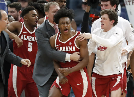 Alabama’s Collin Sexton, center, is congratulated by teammates after making a game-winning basket at the buzzer Thursday to defeat Texas A&M 71-70. (AP)