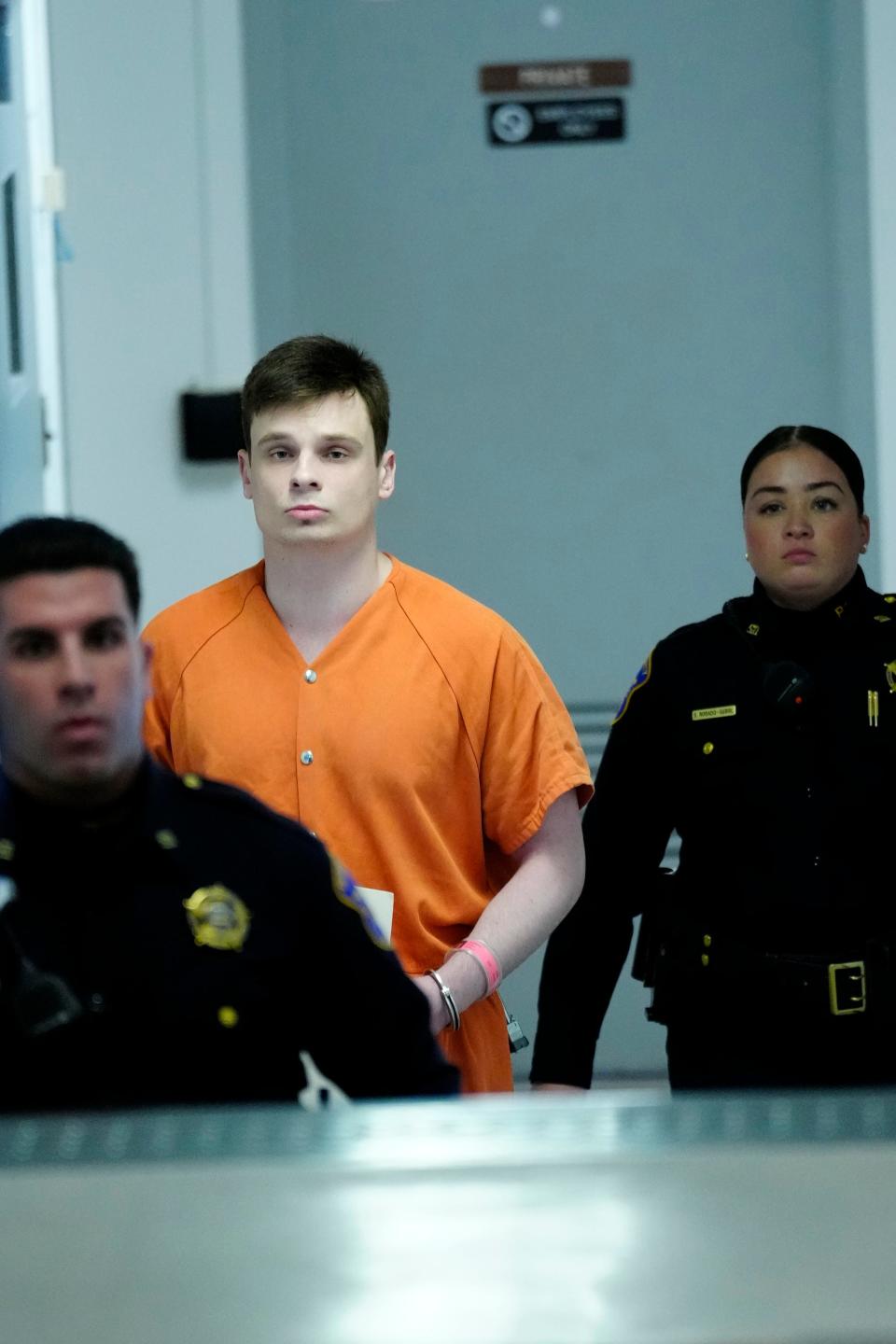 Pawel Sliwinski is shown between Bergen County sheriff's officers as he heads to Judge James Sattely's courtroom in Hackensack on Monday, April 15, 2024. Sliwinski was sentenced to seven years after previously pleading guilty to first-degree kidnapping and other charges.