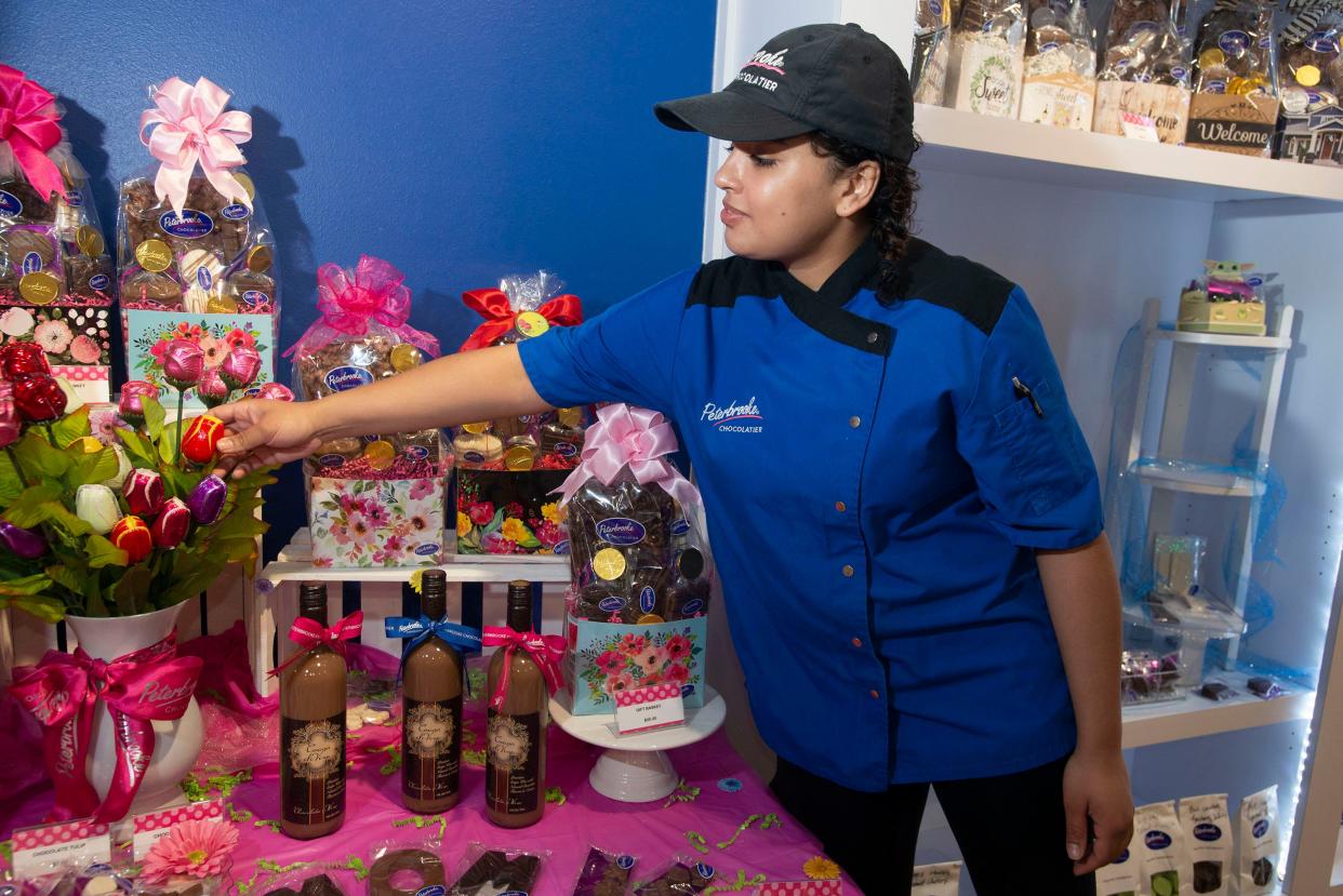 Amanda Rosado sets up a Mother's Day display Monday at Peterbrooke Chocolatier in downtown Pensacola.