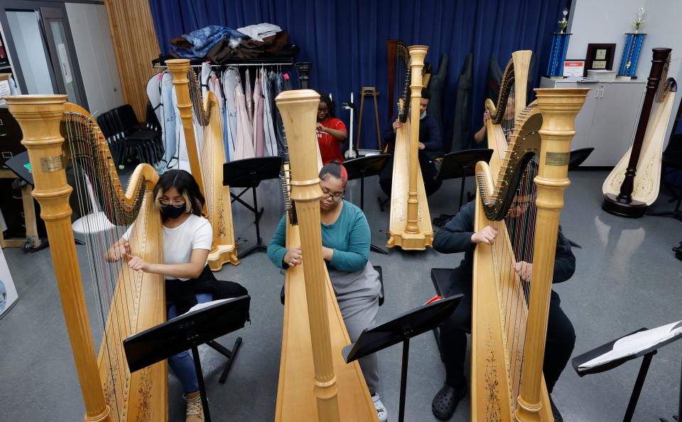 Students in Lydia Cleaver's harp class at Cass Technical High School practice on Friday, March 24, 2023.Cleaver, the director of the school's harp program and an alum of the school, oversees the students and the thirteen harps as they approach their centennial year of the program.