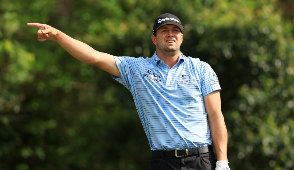   Montgomery points right while watching his tee shot 