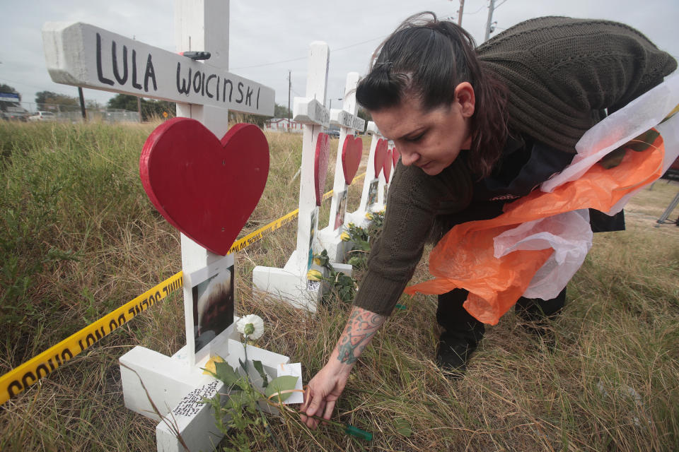 Joyce Mires leaves flowers at Lula Woicinski’s memorial. (Photo: Scott Olson/Getty Images)