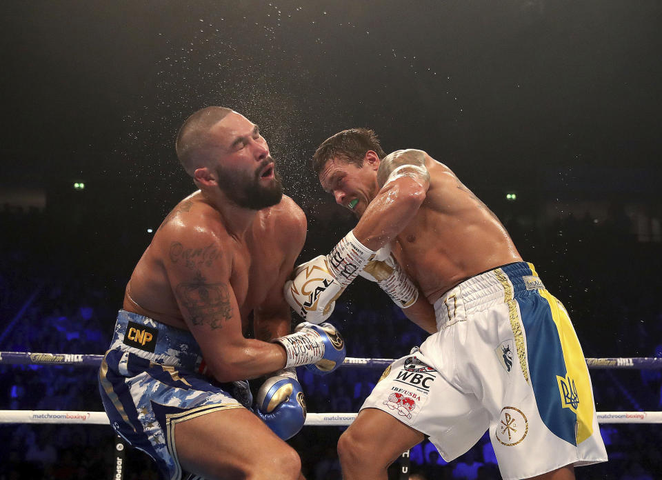 Tony Bellew, left, reacts to a blow from Oleksandr Usyk during their cruiserweight boxing bout Saturday, Nov. 10, 2018, in Manchester, England. Usyk successfully defended his four belts and likely sent Bellew into retirement by knocking out the British fighter in the eighth round. (Nick Potts/PA via AP)