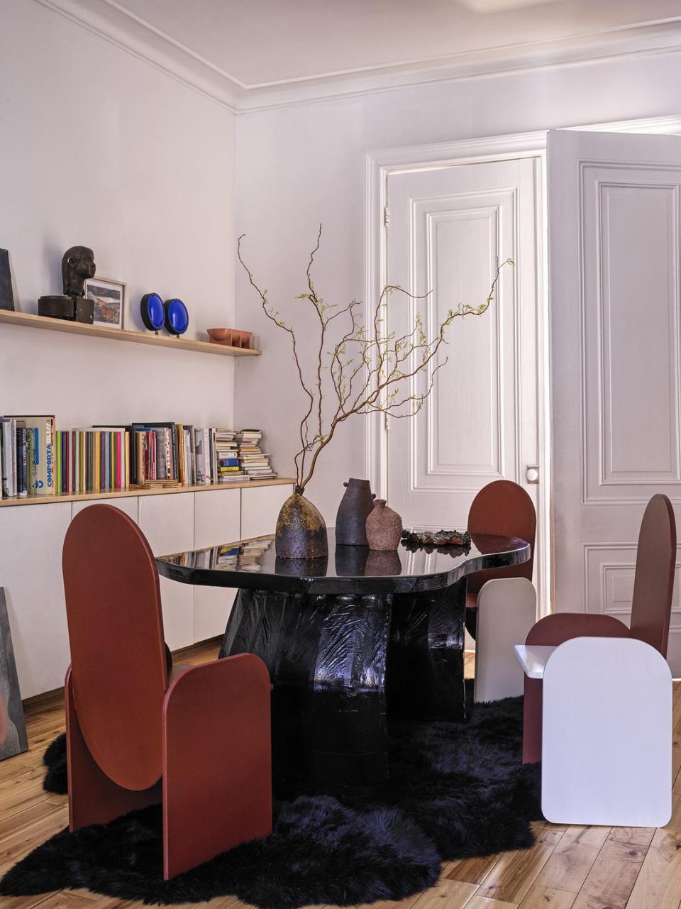 a living room with a table and chairs