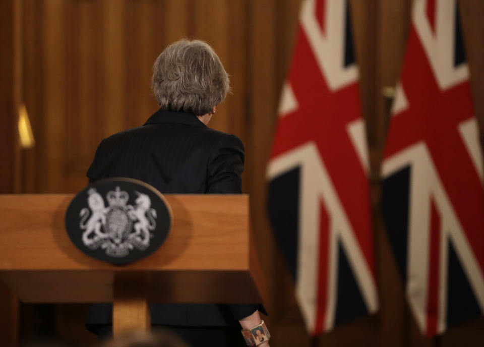 Britain's Prime Minister Theresa May leaves after a press conference inside 10 Downing Street in London, Thursday, Nov. 15, 2018. Two British Cabinet ministers, including Brexit Secretary Dominic Raab, resigned Thursday in opposition to the divorce deal struck by Prime Minister Theresa May with the EU — a major blow to her authority and her ability to get the deal through Parliament. (AP Photo/Matt Dunham, Pool)