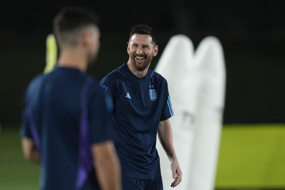 Lionel Messi jokes with teammates during a training of Argentina on the eve of a group C World Cup soccer match against Poland in Doha, Qatar, Tuesday, Nov. 29, 2022. (AP Photo/Jorge Saenz)