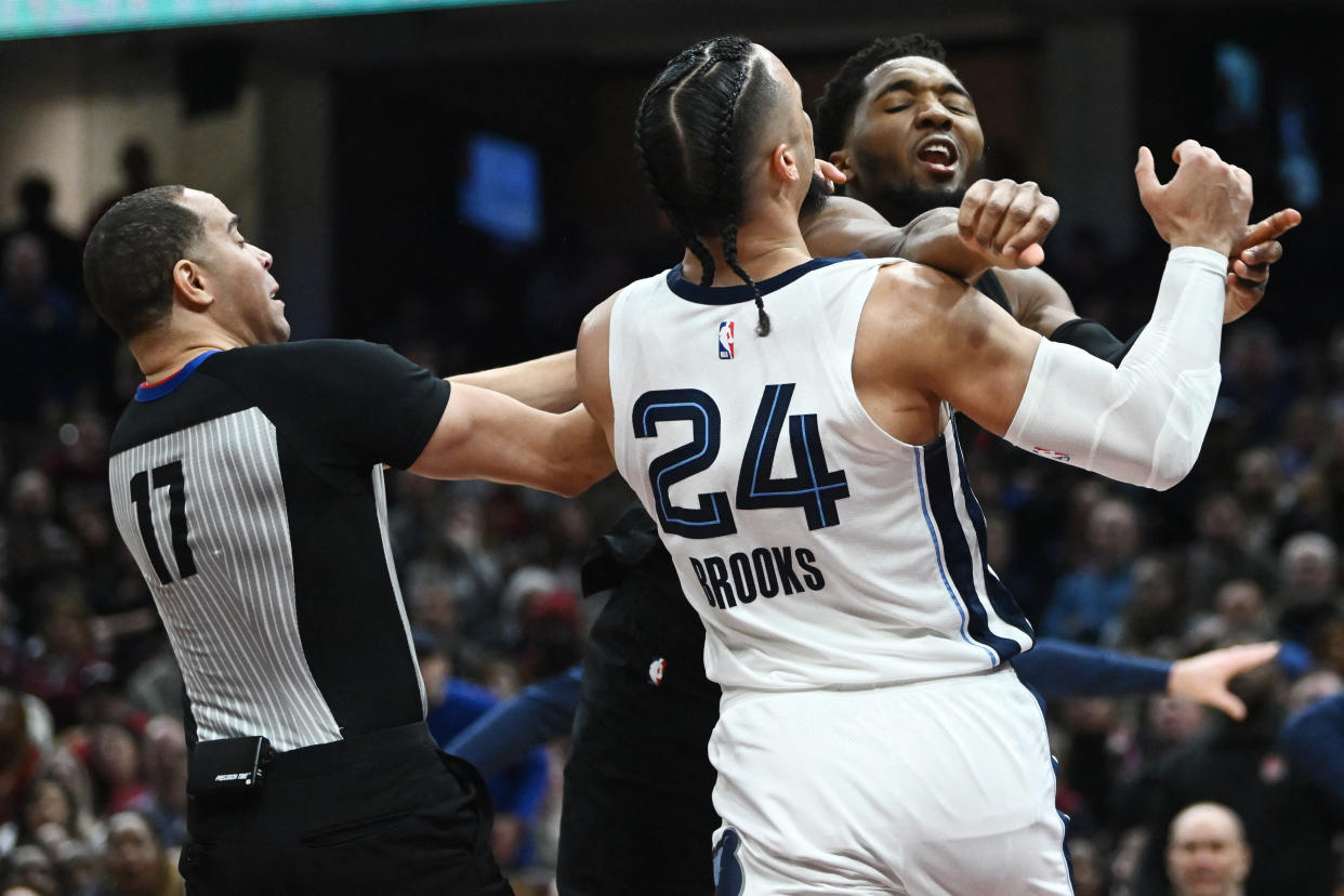  Donovan Mitchell (45) throws a punch at Memphis Grizzlies forward Dillon Brooks (24) 