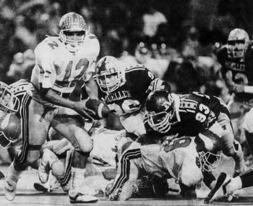 NOVEMBER 4, 1988: Princeton's Johnny Mattress keeps the ball for a short gain against Moeller Friday.