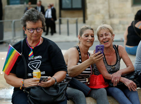 People use their phones during celebrations after the Maltese parliament voted to legalise same-sex marriage on the Roman Catholic Mediterranean island, in Valletta, Malta July 12, 2017. REUTERS/Darrin Zammit Lupi