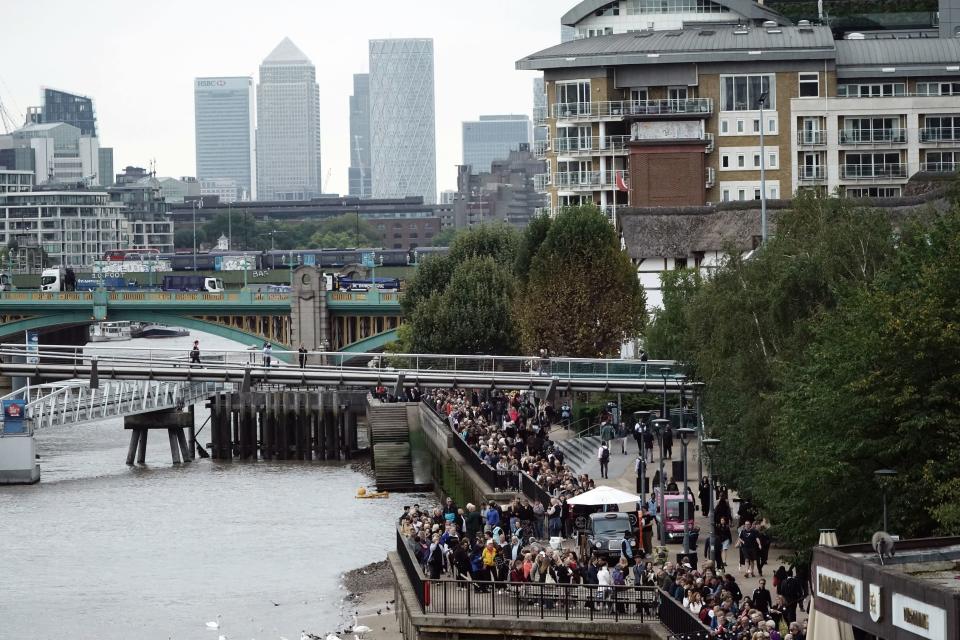 Members of the public in the queue on the South Bank in central London (PA)
