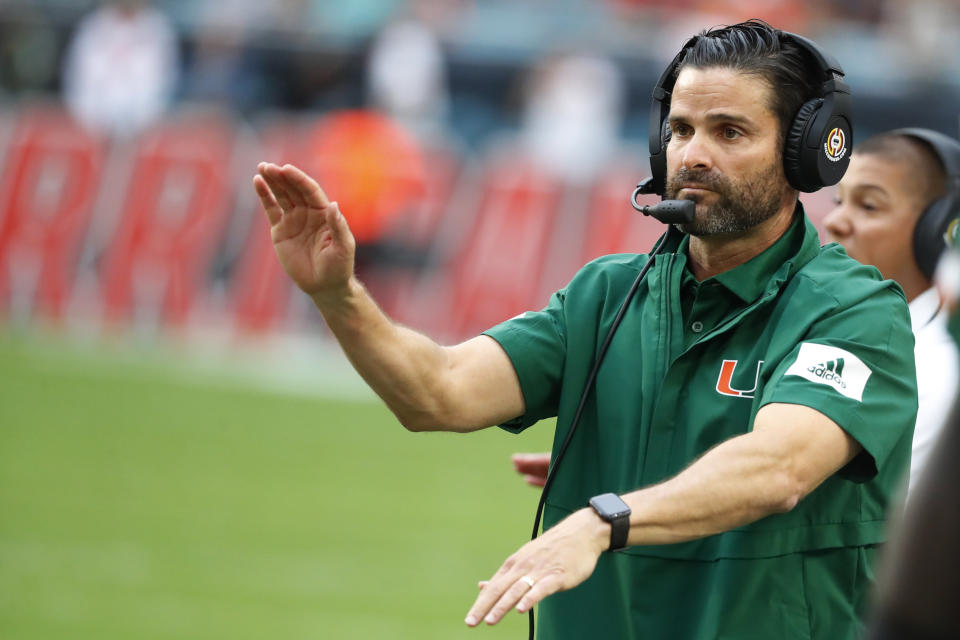 FILE - In this Saturday, Nov. 9, 2019, file photo, Miami head coach Manny Diaz calls out a play during the first half of an NCAA college football game against Louisville in Miami Gardens, Fla. Normally, in March, college football teams all over the country would be preparing for the upcoming season. That's gone now, because of the new coronavirus pandemic, and coaches are trying to figure out how to recreate some of what has been lost. (AP Photo/Wilfredo Lee, File)