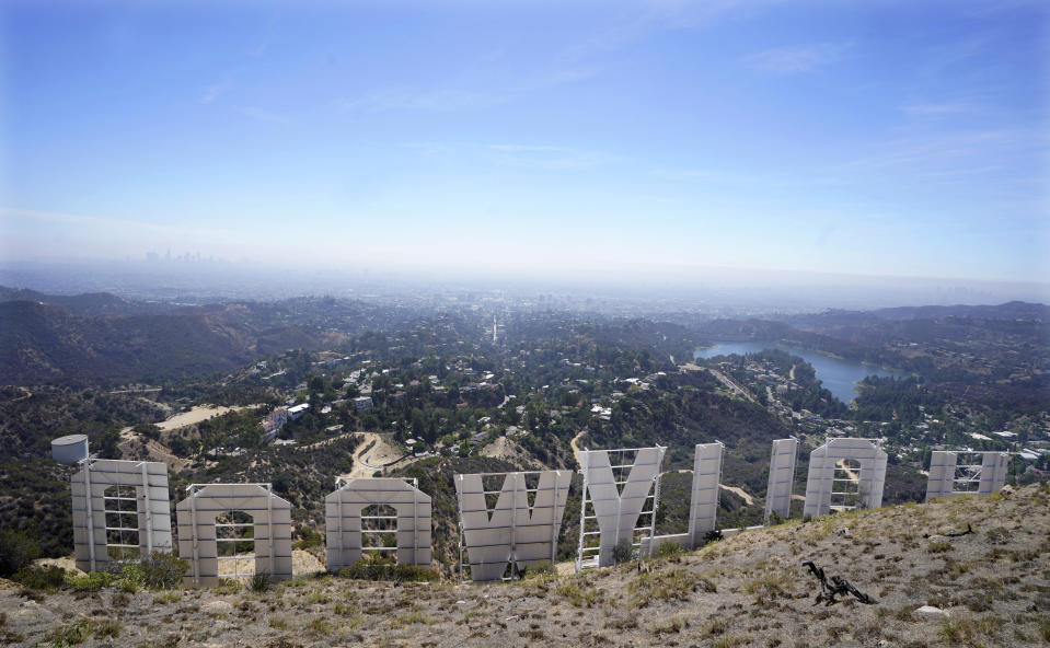 FILE — The back of the Hollywood sign is pictured on Sept. 29, 2022, in Los Angeles. The Hollywood sign is getting a makeover befitting its status as a Tinseltown icon. After a pressure-wash and some rust removal, workers this week began using 250 gallons of primer and white paint to spruce up the sign ahead of its centennial next year. (AP Photo/Chris Pizzello, File)