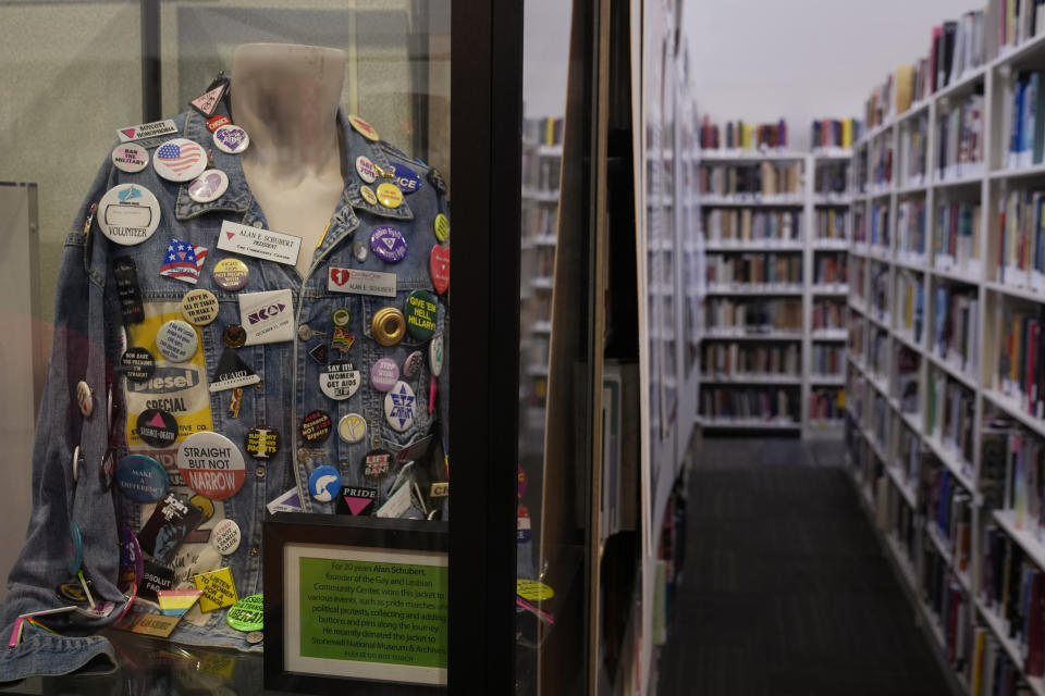 A pin display anchors a section of the Stonewall Museum Library, Wednesday, June 26, 2024, in Fort Lauderdale, Fla. The Stonewall Museum hosts a comprehensive archive on LGBTQ+ history and the largest library collection in the world. The museum is one of hundreds of art and culture groups in the state that are left scrambling to plug a large budget gap after Gov. Ron De Santis vetoed $32 million in arts funding. (AP Photo/Marta Lavandier)