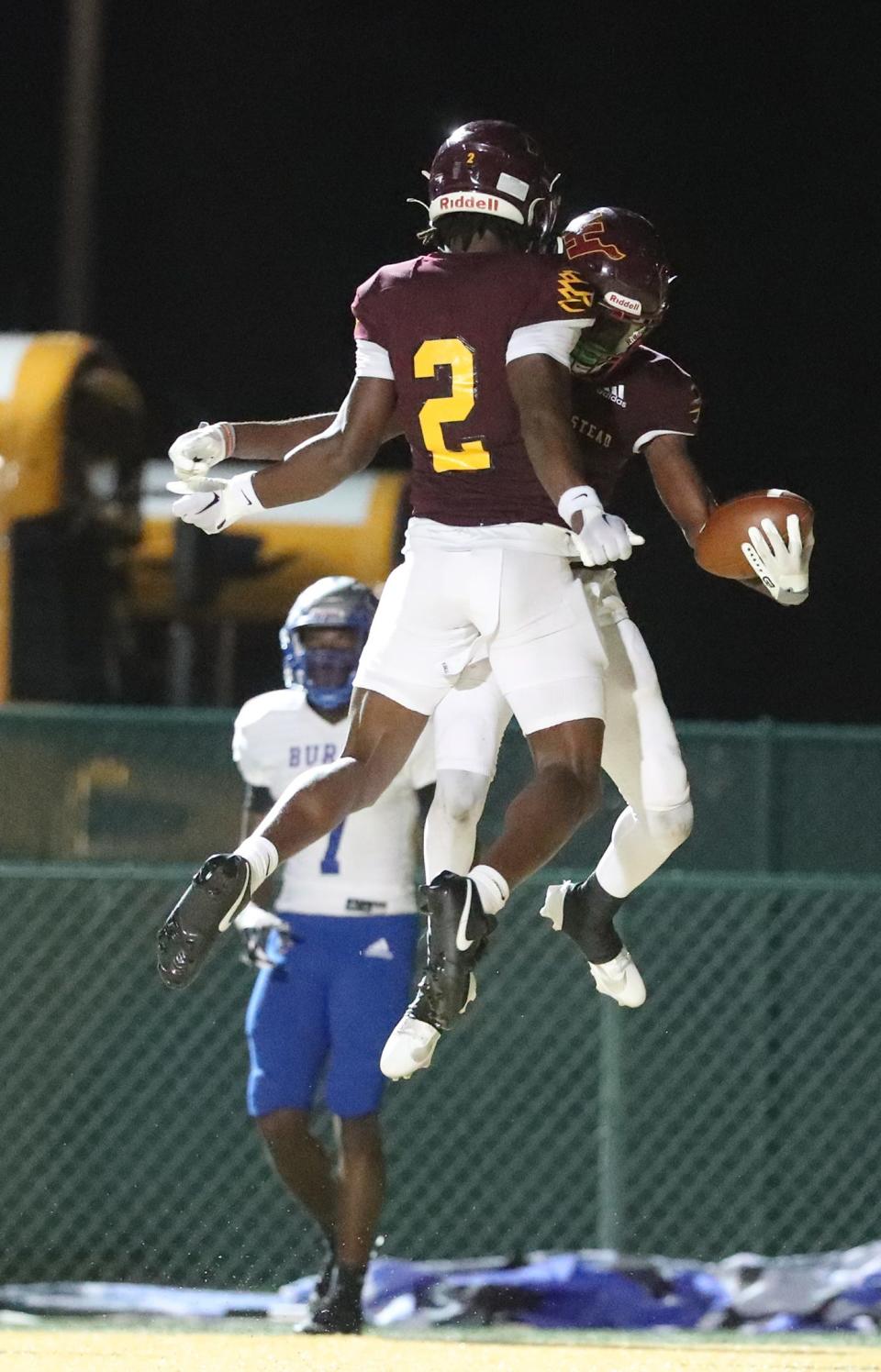 New Hampstead receiver Jaylen Hampton (2) celebrates with teammate Malachi Lonnon after he scored a touchdown during Thursday night's game against Burke County.