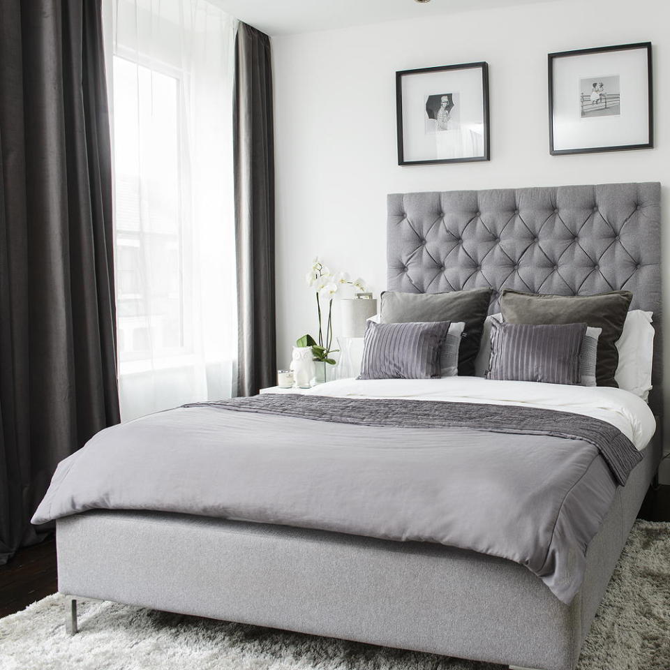 bedroom with grey curtains and white walls