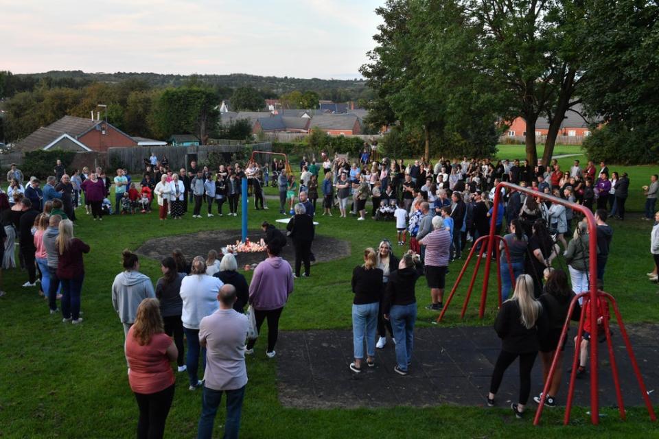 Members of the public attend a vigil at the scene in Chandos Crescent (Anthony Devlin/PA) (PA Wire)