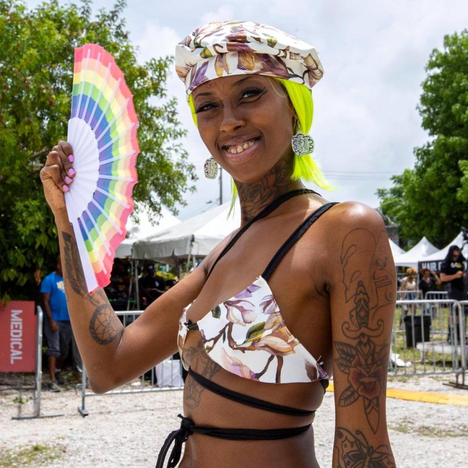 Overtown resident Ya Shiva Robinson, 32, fans herself as she walks the event grounds during AFROPUNK music festival at The Urban in the Historic Overtown neighborhood of Miami, Florida, on Saturday, May 21, 2022.