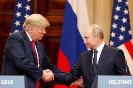 FILE PHOTO: U.S. President Donald Trump and Russian President Vladimir Putin shake hands as they hold a joint news conference after their meeting in Helsinki, Finland July 16, 2018. REUTERS/Grigory Dukor/File Photo