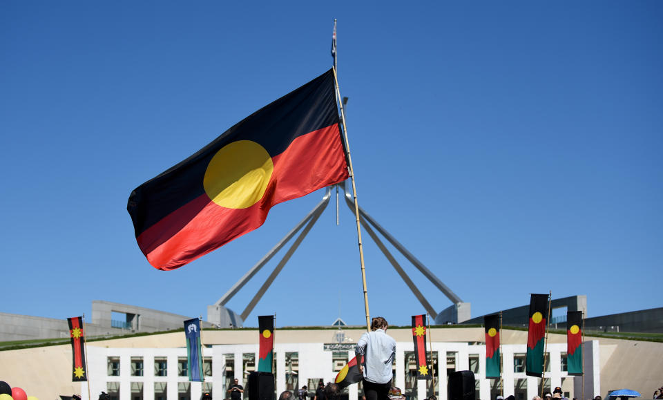 Activists outside Parliament House in Canberra to protest the planned closures of remote Aboriginal communities, Thursday, March 19, 2015.