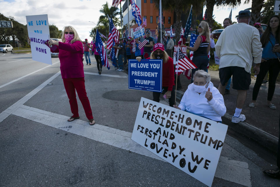 US President Donald Trump supporters wait for the motorcade to pass by on their way to Mar-a-Lago in Palm Beach, Florida, on January 20, 2021. (Photo by Eva Marie UZCATEGUI / AFP) (Photo by EVA MARIE UZCATEGUI/AFP via Getty Images)