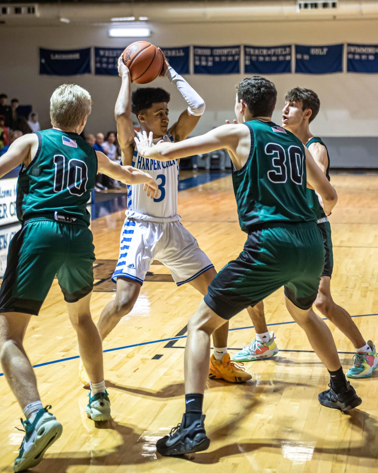 Surrounded by Pennfield defenders, Harper Creek's Keyshaun Matthews looks to pass during first half action at Harper Creek High School on January 14, 2022.