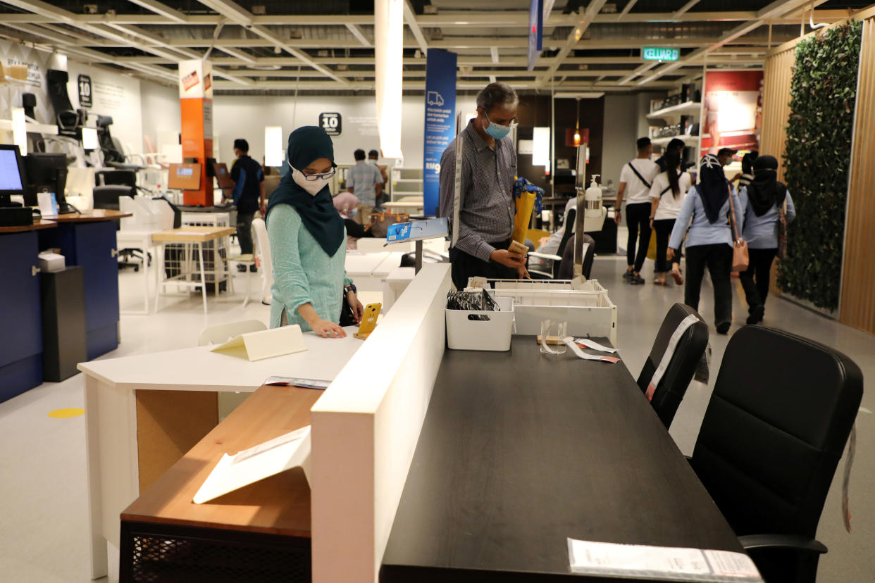 Customers wearing protective masks shop for office furniture at IKEA. Photo: Lim Huey Teng/Reuters