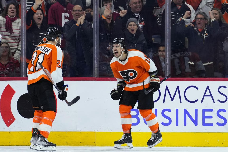 Philadelphia Flyers' Travis Konecny (11) celebrates with Scott Laughton (21) after scoring a goal during the third period of an NHL hockey game against the Washington Capitals, Wednesday, Jan. 11, 2023, in Philadelphia. (AP Photo/Matt Slocum)