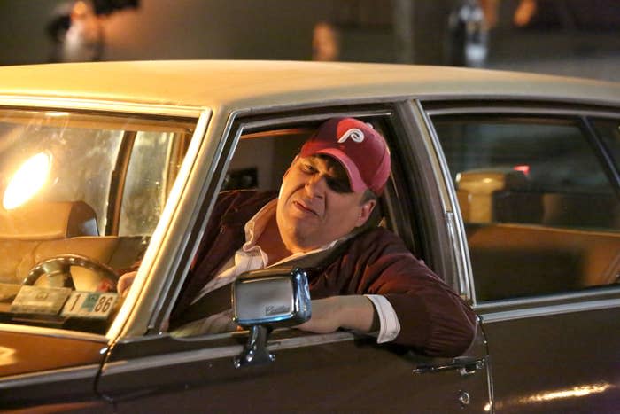 Garlin leans out the driver's seat of his car in a scene from the show