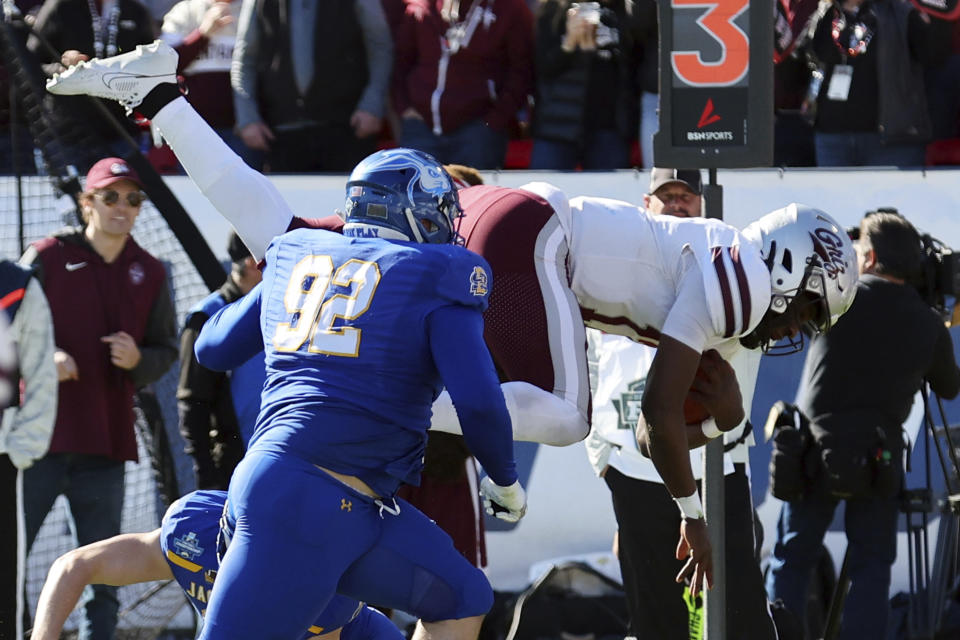 Montana quarterback Clifton McDowell , right, tries to leap past South Dakota State defensive tackle Brian Williams (92) in the first half at the FCS Championship NCAA college football game Sunday, Jan. 7, 2024, in Frisco, Texas. (AP Photo/Richard W. Rodriguez)
