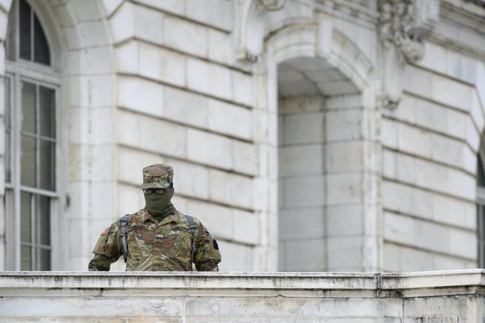 A member of the military stands guard outside Russell Senate Office Building on Capitol Hill