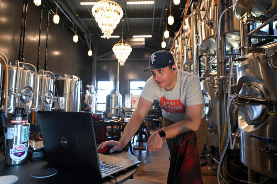 The Farm and the Odd Fellows head brewer Kyle Banman monitors the beer-making process using a laptop at the downtown Minneapolis brewery.